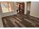 Living room showcasing wood floors, an ornate front door, and an open doorway at 8940 W Olive Ave # 39, Peoria, AZ 85345