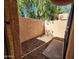 A quaint, enclosed patio features gravel ground cover, mature trees, and stucco walls at 8940 W Olive Ave # 39, Peoria, AZ 85345