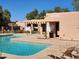 Community pool featuring lounge chairs, covered seating area and manicured landscaping at 8940 W Olive Ave # 39, Peoria, AZ 85345