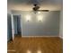 Large bedroom with hardwood floors, and light gray walls at 10910 N 72Nd Dr, Peoria, AZ 85345