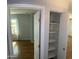 A bedroom closet with shelving is adjacent to the bedroom, which features a window at 10910 N 72Nd Dr, Peoria, AZ 85345