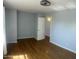A spacious bedroom with blue walls, hardwood floors, and a modern ceiling fan at 10910 N 72Nd Dr, Peoria, AZ 85345