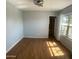 An empty bedroom with blue walls and wood floors and natural light at 10910 N 72Nd Dr, Peoria, AZ 85345