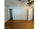Large bedroom with hardwood floors, multiple closets, and a ceiling fan at 10910 N 72Nd Dr, Peoria, AZ 85345