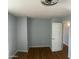 A bedroom with blue walls and wood floors, with a light fixture on the ceiling at 10910 N 72Nd Dr, Peoria, AZ 85345