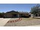 Charming single-story home boasts low-maintenance desert landscaping and a quaint stone walkway leading to the front door at 10910 N 72Nd Dr, Peoria, AZ 85345