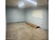 An unfinished garage space, providing potential for a workshop or additional storage with natural light at 10910 N 72Nd Dr, Peoria, AZ 85345