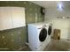 Spacious laundry area with modern Samsung washer/dryer units and ample storage solutions at 10910 N 72Nd Dr, Peoria, AZ 85345