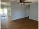 Open-plan living room showcasing hardwood floors and connecting to the kitchen at 10910 N 72Nd Dr, Peoria, AZ 85345