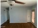 Living room featuring hardwood floors, ceiling fan, and access to a large closet and door to the backyard at 10910 N 72Nd Dr, Peoria, AZ 85345