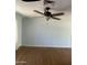 A well-lit living room with hardwood floors featuring a modern ceiling fan for comfortable living at 10910 N 72Nd Dr, Peoria, AZ 85345