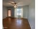 Living room featuring hardwood floors, back door and window with sheer curtains at 10910 N 72Nd Dr, Peoria, AZ 85345