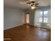 Bright living room featuring hardwood floors, back door and window with sheer curtains at 10910 N 72Nd Dr, Peoria, AZ 85345