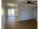 Spacious living room featuring hardwood floors with an open-plan kitchen and backyard access at 10910 N 72Nd Dr, Peoria, AZ 85345
