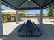 Shaded picnic area with tables offers a comfortable space for outdoor dining at 10910 N 72Nd Dr, Peoria, AZ 85345