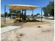 Playground with a covered structure provides shade for play, enhancing outdoor fun and safety at 10910 N 72Nd Dr, Peoria, AZ 85345