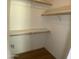 A bright walk-in closet with modern shelving and hardwood floors provides ample storage space at 10910 N 72Nd Dr, Peoria, AZ 85345