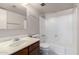 Bathroom with a single sink vanity and shower and tub with a glass door at 11026 N 28Th Dr # 81, Phoenix, AZ 85029
