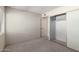 Bright bedroom with carpet, closet with sliding doors, and direct access to closet at 11026 N 28Th Dr # 81, Phoenix, AZ 85029