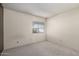 Bedroom featuring a window with blinds and neutral paint to allow customizable decor at 11026 N 28Th Dr # 81, Phoenix, AZ 85029