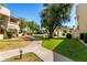 Beautifully landscaped courtyard with mature trees, walking paths, and common parking areas at 11026 N 28Th Dr # 81, Phoenix, AZ 85029