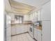 This functional kitchen has white cabinetry, laminate countertops and tiled floor at 11026 N 28Th Dr # 81, Phoenix, AZ 85029