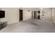 Open-concept living room featuring neutral decor, carpeting, and access to other rooms at 11026 N 28Th Dr # 81, Phoenix, AZ 85029