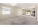 Spacious living room with neutral carpet, sliding glass door, and modern ceiling fan at 11026 N 28Th Dr # 81, Phoenix, AZ 85029