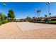 Wide open parking lot featuring clearly marked spaces and mature trees for shade at 11026 N 28Th Dr # 81, Phoenix, AZ 85029