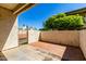 Private outdoor patio featuring brick and concrete flooring, a gate, and views of lush landscaping at 11026 N 28Th Dr # 81, Phoenix, AZ 85029