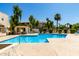 Community pool with ample lounge chairs, lush landscaping and nearby condominium buildings at 11026 N 28Th Dr # 81, Phoenix, AZ 85029