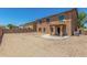 Expansive backyard featuring a patio, gravel landscaping, and a privacy wall, perfect for outdoor enjoyment at 11871 W Sherman St, Avondale, AZ 85323