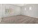 Clean, carpeted bedroom featuring white walls, window, and plantation shutters at 11871 W Sherman St, Avondale, AZ 85323