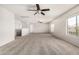Expansive loft area with neutral carpet, bright windows, and dual ceiling fans at 11871 W Sherman St, Avondale, AZ 85323