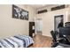 This secondary bedroom features wood floors, a closet, overhead storage and plenty of natural light at 1222 W Baseline Rd # 119, Tempe, AZ 85283