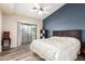 Bright bedroom features wood floors, a ceiling fan, and a sliding glass door to the outside patio at 1222 W Baseline Rd # 119, Tempe, AZ 85283
