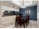 The dining area features a dark wood table and chairs beneath an elegant chandelier lighting at 1222 W Baseline Rd # 119, Tempe, AZ 85283