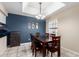 The dining area features a dark wood table and chairs beneath an elegant chandelier lighting at 1222 W Baseline Rd # 119, Tempe, AZ 85283