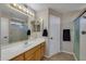 Well-lit bathroom featuring tile floors, a shower, and a vanity with a sink and mirror, combining style and functionality at 12720 W Cantenia Rd, Avondale, AZ 85392