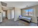 Well-lit bedroom featuring neutral walls, carpet, a twin bed, and easy access to the ensuite bathroom at 12720 W Cantenia Rd, Avondale, AZ 85392