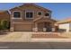 Two-story home featuring a covered porch, low maintenance front yard, and an attached two-car garage at 12720 W Cantenia Rd, Avondale, AZ 85392