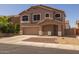 Two-story home featuring a covered porch, low maintenance front yard, and an attached two-car garage at 12720 W Cantenia Rd, Avondale, AZ 85392