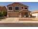 Two-story home featuring neutral-colored stucco, desert landscaping and a two car garage at 12720 W Cantenia Rd, Avondale, AZ 85392