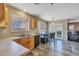 Eat-in kitchen with wood floors, stainless steel sink, laminate countertops, and access to the backyard at 12720 W Cantenia Rd, Avondale, AZ 85392
