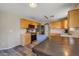 Eat-in kitchen with wood floors, stainless steel appliances, laminate countertops, and wooden cabinets at 12720 W Cantenia Rd, Avondale, AZ 85392