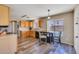 Eat-in kitchen with wood floors, stainless steel sink, laminate countertops, and a view of the backyard at 12720 W Cantenia Rd, Avondale, AZ 85392