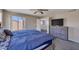 Inviting main bedroom featuring carpet, a ceiling fan, and large windows offering ample natural light and loft access at 12720 W Cantenia Rd, Avondale, AZ 85392