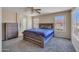 Inviting main bedroom featuring carpet, a ceiling fan, and large windows offering ample natural light and neighborhood views at 12720 W Cantenia Rd, Avondale, AZ 85392