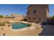 Backyard pool and patio featuring unique rock waterfall features and mature desert landscaping at 12720 W Cantenia Rd, Avondale, AZ 85392