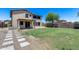 Sprawling backyard showcases lush lawn and stone walkway adjacent to the home's exterior at 1359 E 12Th St, Casa Grande, AZ 85122
